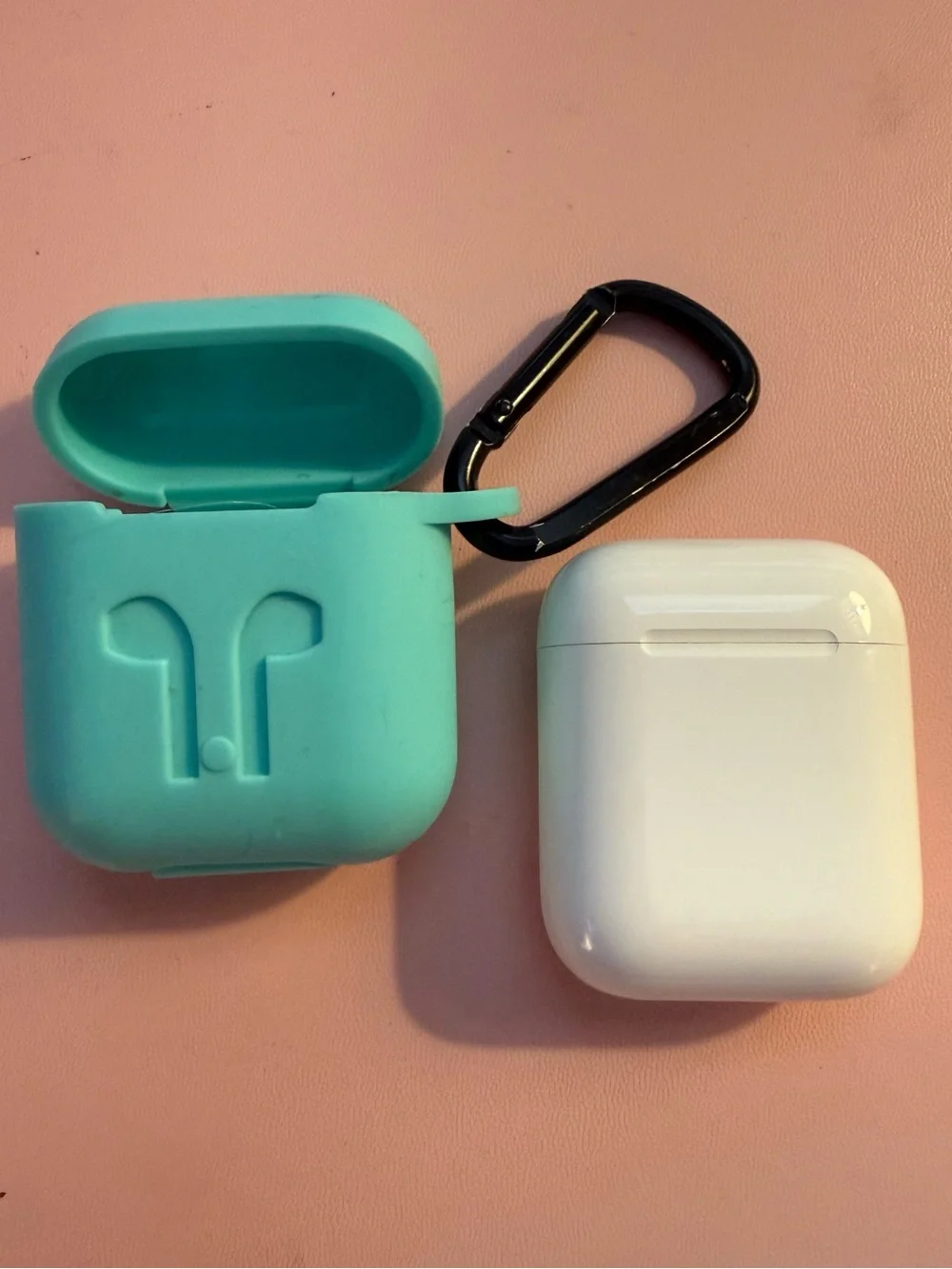 Apple White Wireless AirPods with Charging Case and silicone carrier.